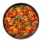 Chicken Vindaloo with spinach in black bowl isolated on white. Indian cuisine meat chilli curry dish. Asian food