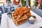 Chicken and Waffle served on a square plate