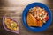 Chicken wing with vegetable salad on a wooden background