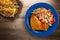 Chicken wing with vegetable salad on a wooden background