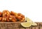 Chicken wings with lime wedge, salt and peppercorn on wooden table.