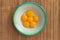 Chicken yolks lie in a white plate with a green border