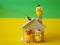 Chickens, wooden house and coins, one chick on chimney