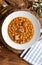 Chickpea stew dish potage - cocido madrileÃ±o. With beef, sausage chorizo, bacon, carrots and olive oil. Rustic appearance.