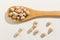 Chickpeas legume. Healthy grains on a wooden spoon. White background.
