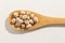 Chickpeas legume. Nutritious grains on a wooden spoon on white b