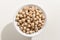 Chickpeas legume. Top view of grains in a bowl. White background