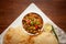 Chickpeas masala Spicy chola or chhole curry and Bhatura or Puri  garnished with fresh green coriander and ingredients.