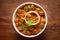 Chickpeas masala Spicy chola or chhole curry  garnished with fresh green coriander and ingredients. Served in a ceramic bowl.