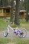 Chidren pink bicycle in wooden cabin mountain