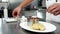 Chief-cooker prepares food on professional kitchen in restaurant, caviar with grilled vegetables with croutons