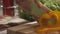 Chief cutting yellow peppers on a wooden board with a professional knife and a great skill. Scene. Close-up of chief