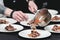 Chief serving homemade bone-in prime rib roast on a white plate