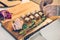 Chief styling the food appetizers on wooden tray on even catering service.