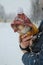 Chihuahua dog in a fashionable jacket in the arms of the owner in winter on a walk