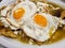 chilaquiles dish with fried egg for lunch, traditional mexican food