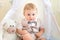 Child 1 year a boy in a suit sits with a bear in a wigwam in a photo Studio, Birthday of a child 1 year