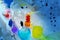 child 7-9 years old, elementary school boy, do chemical experiments, pour colored liquids into glass flasks, mix colors, school