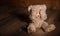 Child abuse.Teddy bear covering eyes, dark empty background, copy space