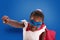 Child acts like a superhero to save the world on blue background