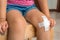 Child with adhesive bandage on knee
