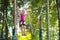 Child in adventure park. Kids climbing rope trail.