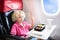 Child in airplane. Kids fly. Children flight meal