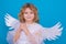 Child angel. Portrait of cute kid with angel wings isolated on studio background. Little angel, valentines day. Angelic