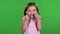 Child is angry, she is very nervous. Green screen. Slow motion