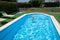 Child with armbands in pool with face expression