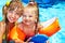 Child with armbands in swimming pool