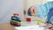 Child arms sculpts figures out of plasticine on table