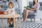 A child with Asperger Syndrome playing with wooden blocks during a therapeutic meeting with a therapist in a family support center