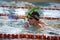 Child athlete swims in the pool