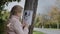 A child attaches a leaflet about a missing cat to a pole. Pet Search Concept