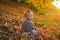 Child autumn leaves background. Warm moments of autumn. Toddler boy blue eyes enjoy autumn. Small baby toddler on sunny