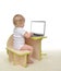 Child baby girl toddler typing on modern computer laptop keyboard