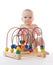 Child baby toddler sitting and playing wooden educational toy