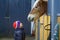 A child on the background of a paddock for horses in the room. Portrait of a village boy on the background of a cattle stall