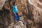 A child with a backpack drinks water from a refillable bottle