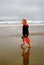 Child on Beach with Red Bucket