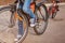 Child on a bicycle at asphalt road in sunny spring day. Closeup on pedal and foot