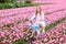 Child on bike in tulip field. Bicycle in Holland