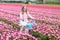 Child on bike in tulip field. Bicycle in Holland