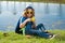 Child with binoculars travelling outdoors. Boy traveler with backpack in a summer day. Portrait of a little boy