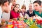 Child on birthday party blowing candles on cake