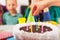 Child on birthday party prepared blowing candles on cake, selective focus