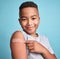 .Child black, band aid and happy kid with vaccine, in blue studio background and relax with smile or joyful. Portrait