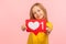 Child blog, trendy content. Portrait of adorable cheerful little girl showing heart like icon of social media