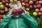 Child blond boy lying on the green grass background with apples glasses